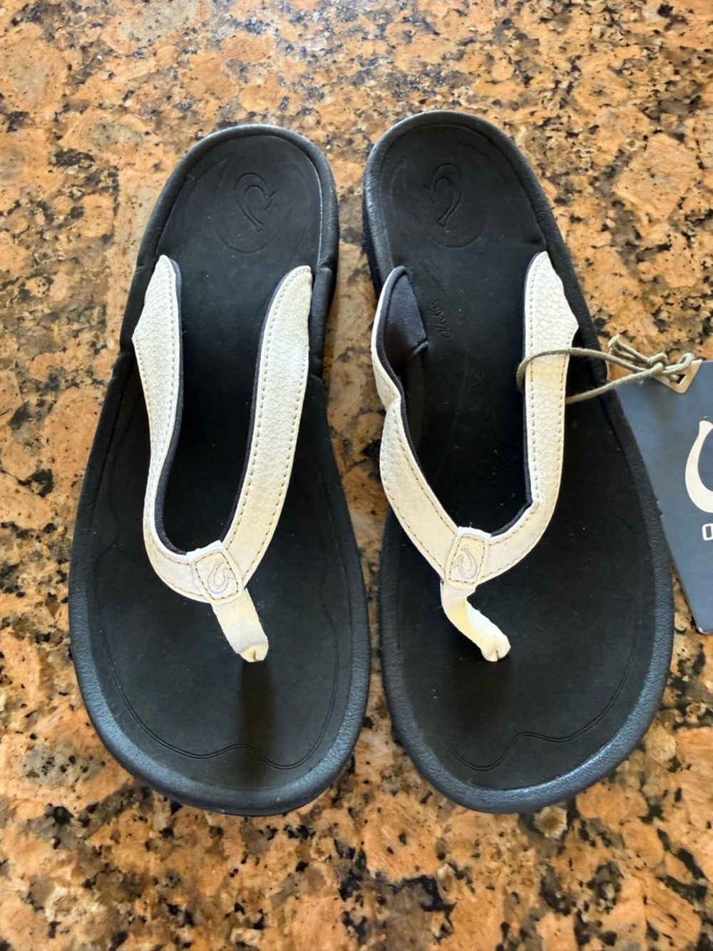 Olukai Women's Kulapa Kai Black Footbed Flip Flops with White Straps